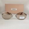 Miu Miu — Gafas ovaladas con lentes marrón claro