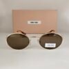 Miu Miu — Gafas ovaladas doradas con lentes marrones