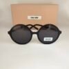 Miu Miu — Gafas redondas negras con lentes oscuros