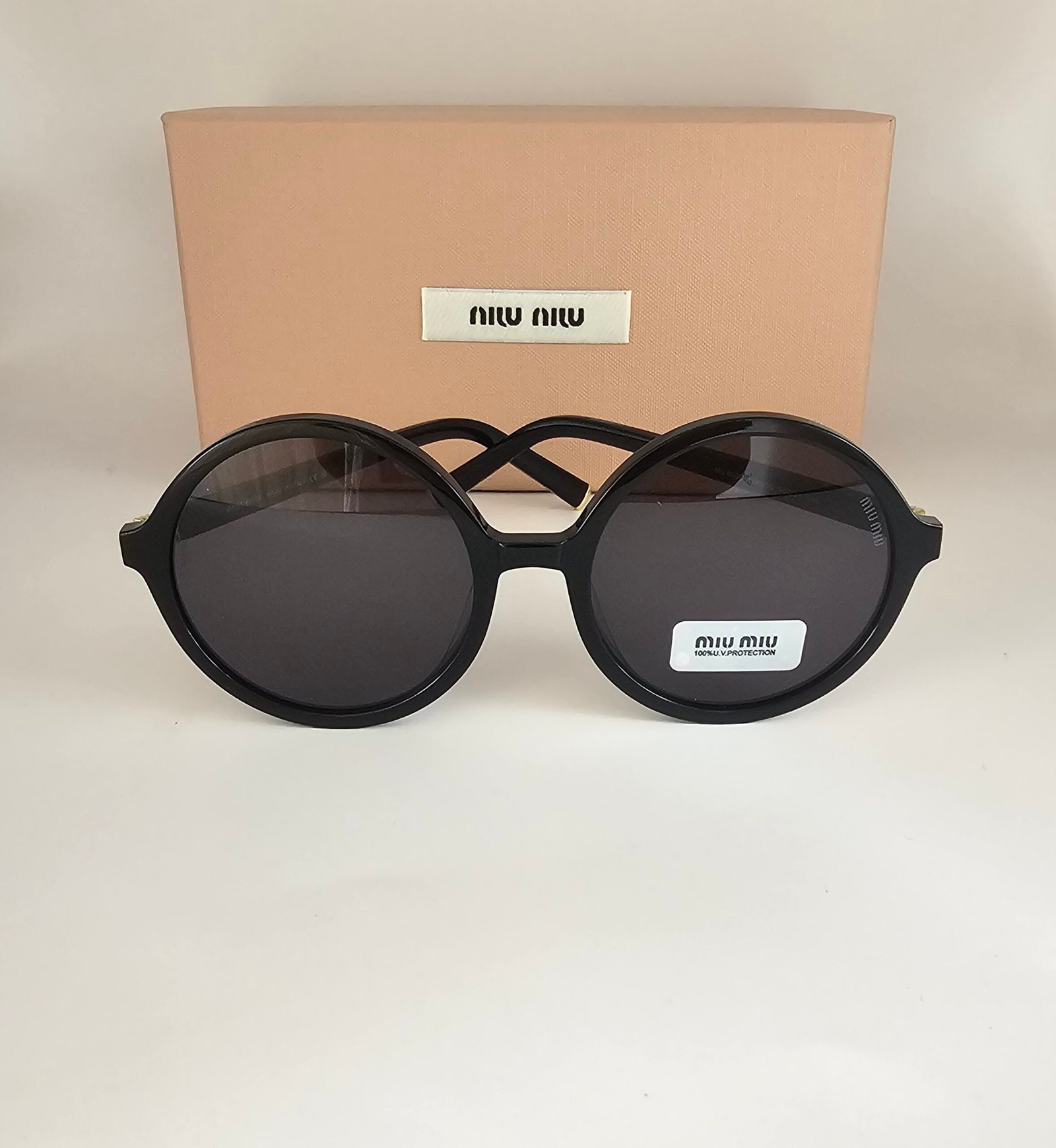 Miu Miu — Gafas redondas negras con lentes oscuros