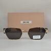 Miu Miu — Gafas rectangulares doradas y negras