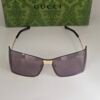 Gucci — Gafas envolventes doradas con lentes gris violeta
