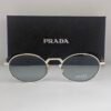 Prada — Gafas ovaladas con lentes gris azulado