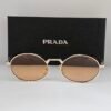 Prada — Gafas ovaladas con lentes marrones