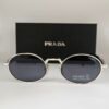 Prada — Gafas ovaladas con lentes violeta oscuro