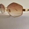 Dior — Gafas geométricas doradas con lentes marrón degradado