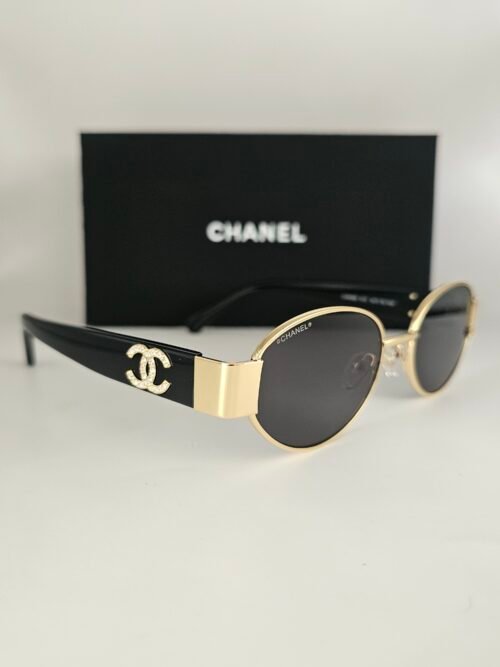 Chanel — Gafas ovaladas negras y doradas