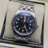 IWC — esfera negra con numeración blanca y brazalete plateado