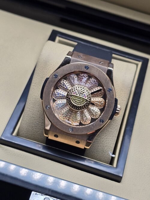 Hublot — esfera con diseño radial brillante y caja en tono dorado