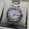 Cartier — esfera blanca redonda y brazalete bicolor dorado