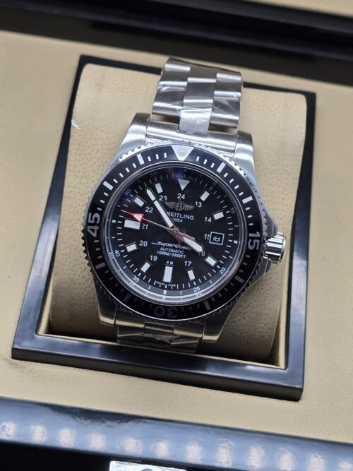 Breitling — esfera negra deportiva y brazalete plateado