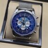 Breitling — esfera azul con diseño de mapa y brazalete de malla