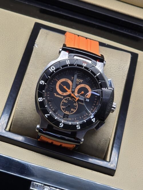 Tissot — esfera negra con detalles naranjas y correa naranja