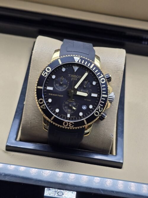 Tissot — esfera negra deportiva con detalles dorados