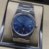 Tissot — esfera azul texturizada y brazalete plateado