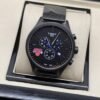Tissot — esfera negra con detalles azules y brazalete oscuro