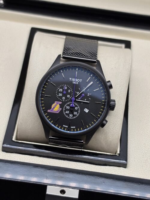 Tissot — esfera negra con detalles amarillos y brazalete oscuro