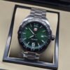 TAG Heuer — esfera verde y brazalete plateado