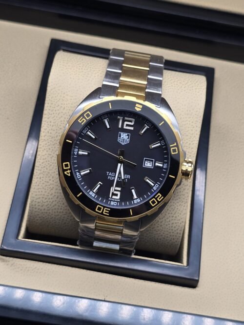 TAG Heuer — esfera negra con detalles dorados y brazalete bicolor