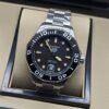 TAG Heuer — esfera negra con bisel negro y brazalete plateado