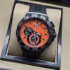 TAG Heuer — esfera naranja con subesferas y correa negra
