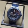 TAG Heuer — esfera azul con detalles naranjas y correa azul