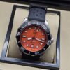 TAG Heuer — esfera naranja y correa perforada negra