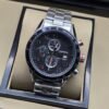 TAG Heuer — esfera negra con tres subesferas y brazalete plateado