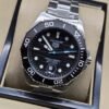 TAG Heuer — esfera negra con subesfera y brazalete plateado