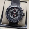 TAG Heuer — esfera abierta plateada con aguja roja y correa negra