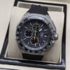 TAG Heuer — esfera negra con aguja amarilla y correa negra