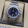Rolex — esfera negra con bisel y brazalete plateados