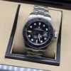 Rolex — esfera negra con bisel negro y brazalete plateado