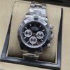 Rolex — esfera negra con tres subesferas plateadas y brazalete plateado