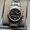 Rolex — esfera negra con subesferas doradas y brazalete bicolor