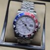 Rolex — esfera gris con patrón y bisel rojo y azul