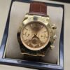 Rolex — esfera dorada con subesferas y correa marrón