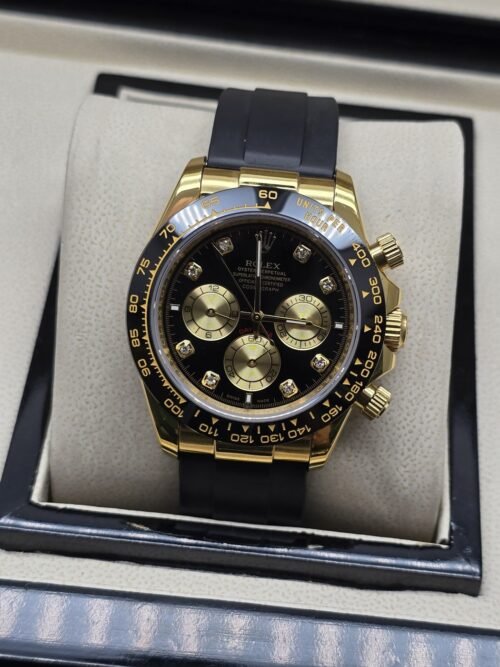 Rolex — esfera oscura con subesferas doradas y correa negra