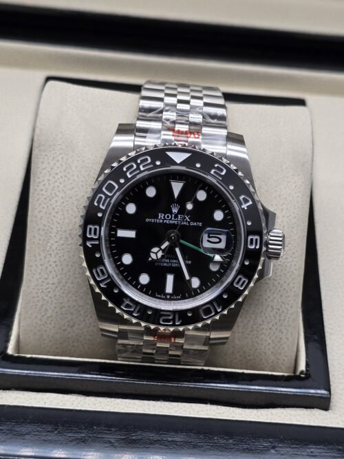 Rolex — esfera negra con bisel negro numerado y brazalete plateado