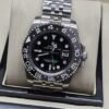 Rolex — esfera negra con bisel numerado y brazalete de eslabones plateados