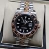 Rolex — esfera negra con bisel marrón y negro, brazalete bicolor