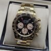 Rolex — esfera negra con subesferas claras y brazalete dorado