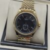 Rolex — esfera negra con subesfera inferior y brazalete dorado