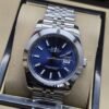 Rolex — esfera azul con bisel liso y brazalete plateado · 41 mm