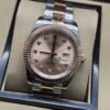 Rolex — esfera rosada con bisel rosado y brazalete bicolor · 41 mm