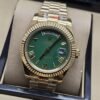 Rolex — esfera verde con bisel dorado estriado y brazalete dorado · 41 mm