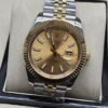 Rolex — esfera dorada con bisel dorado estriado y brazalete bicolor · 41 mm