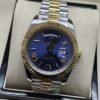 Rolex — esfera azul con bisel dorado y brazalete bicolor · 41 mm