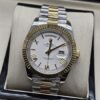 Rolex — esfera blanca con números romanos y bisel dorado y brazalete bicolor · 41 mm