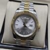 Rolex — esfera gris con bisel dorado y brazalete bicolor · 41 mm